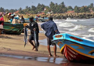 Fisherman bringing in their latest catch on the beach