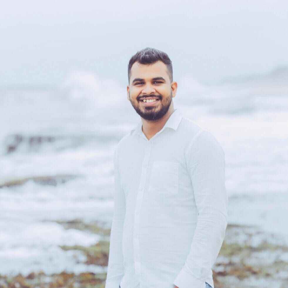 Man standing in front of ocean waves